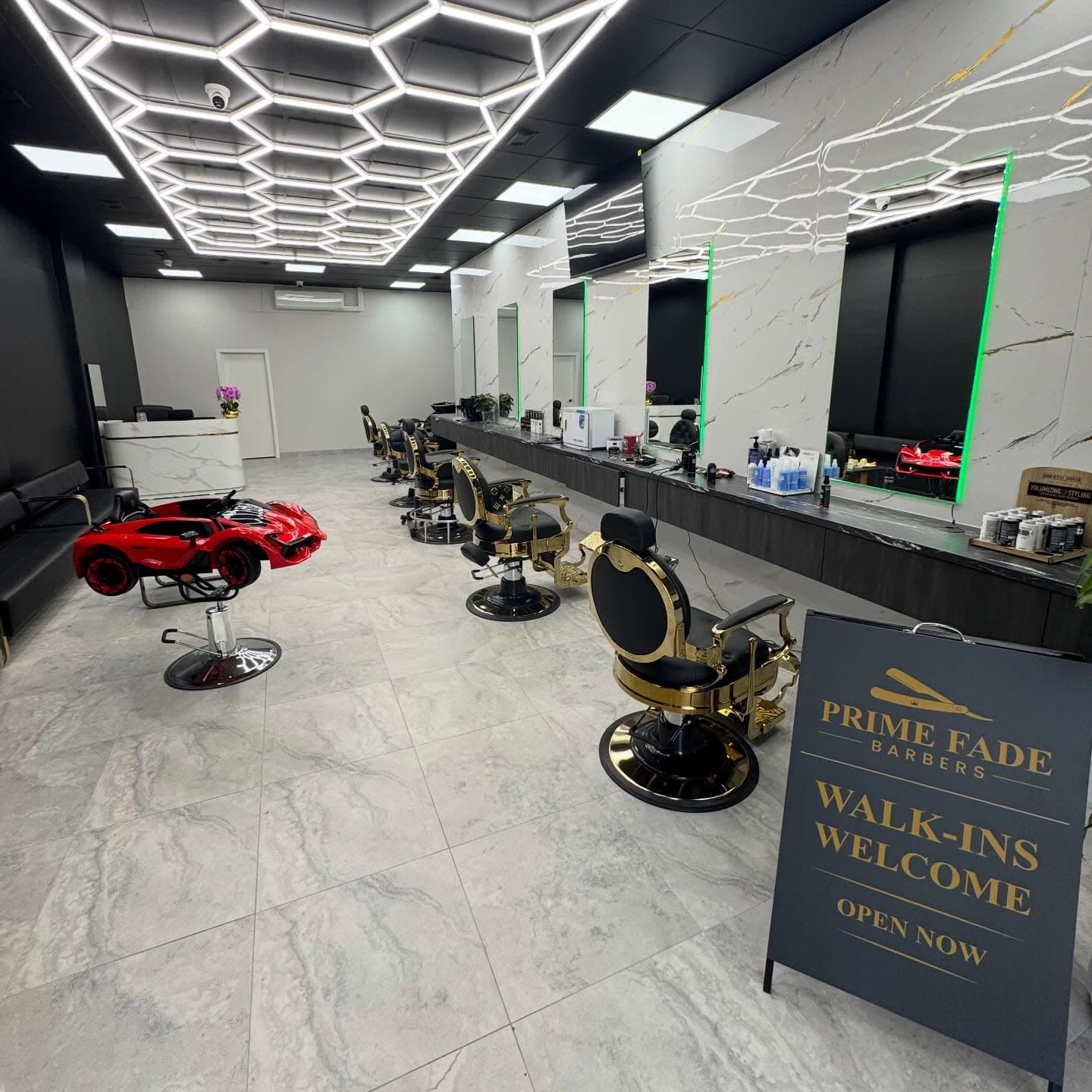 Prime Fade Barbers shop interior with gold chairs and marble stations